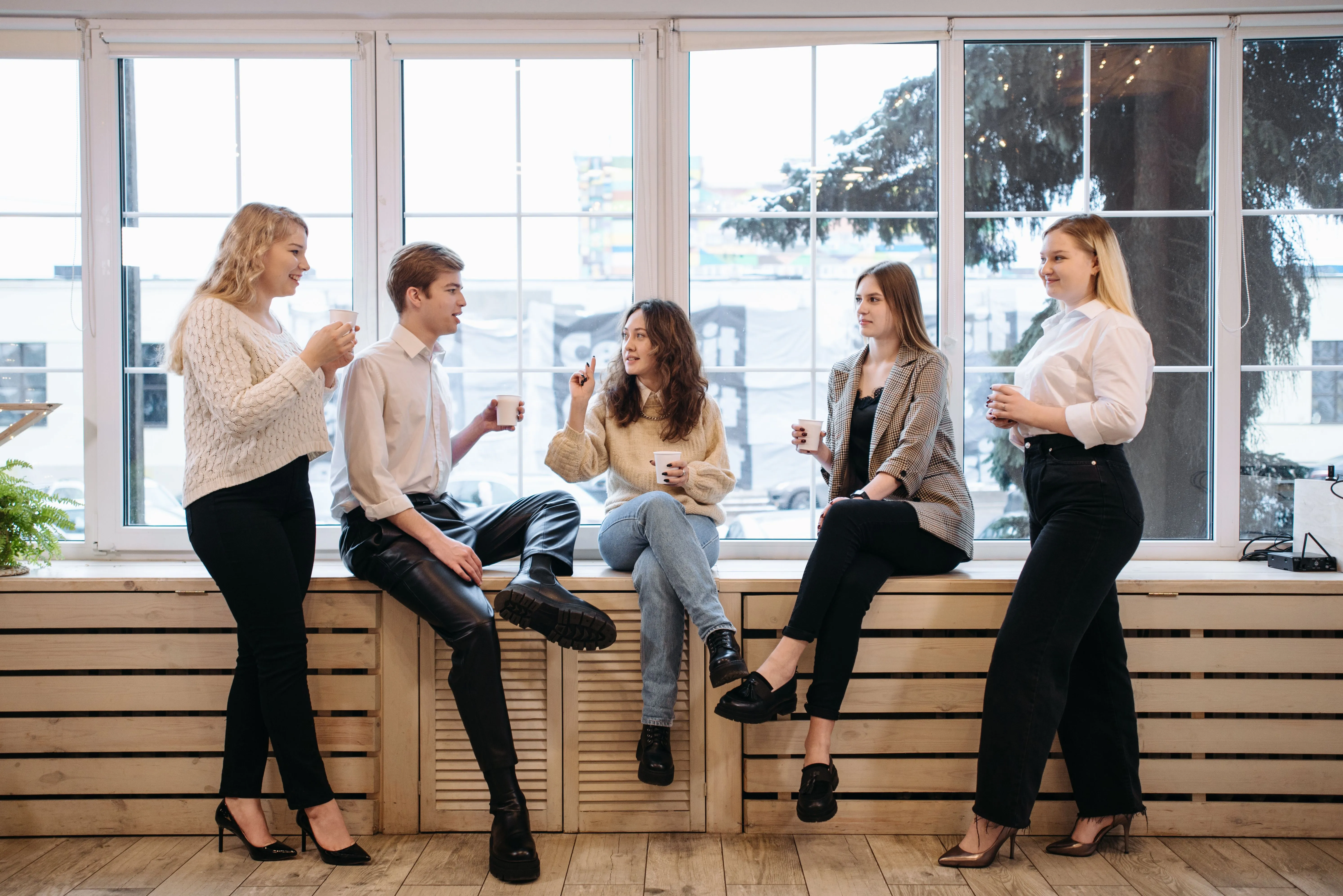 Happy coworkers chatting with drinks during a break